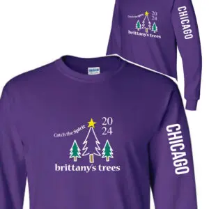 A purple long sleeve shirt with trees and stars.