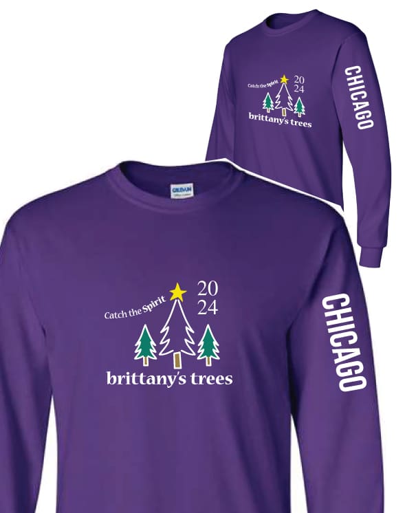 A purple long sleeve shirt with trees and stars.